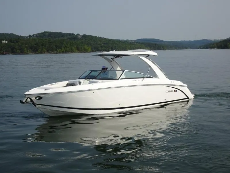 Slide: The Image of 2025 Cobalt R30 boat cruising on a lake with scenic hills in the background. - 10