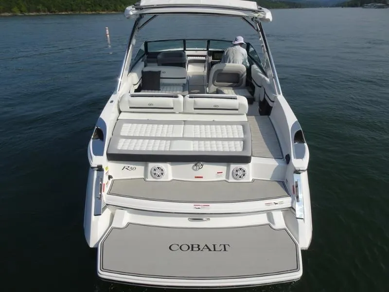 Slide: The Image of 2025 Cobalt R30 boat on water, rear view showing spacious deck and seating. - 12