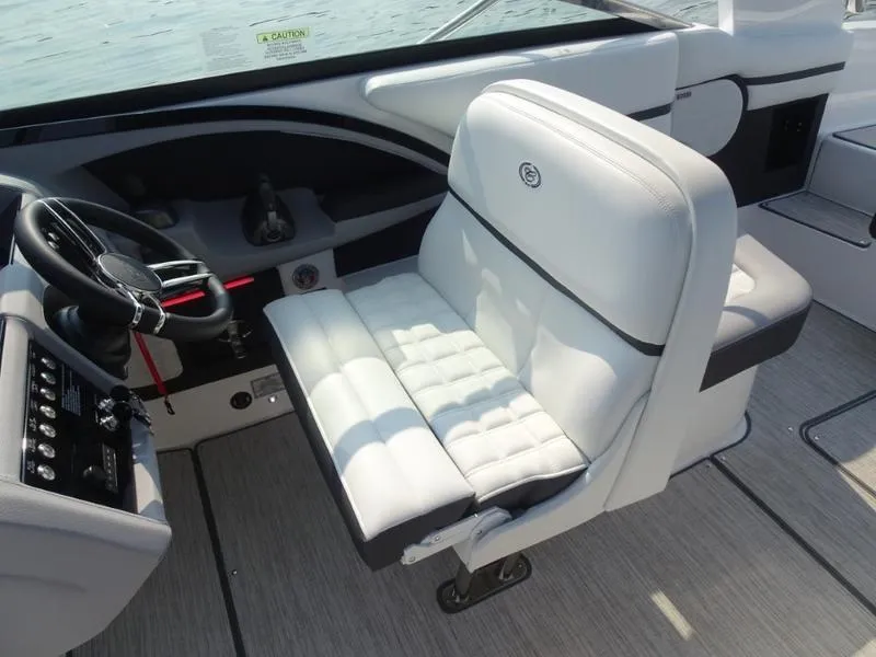 Slide: The Image of Captain's seat and helm of 2025 Cobalt R30 boat with white upholstery. - 16