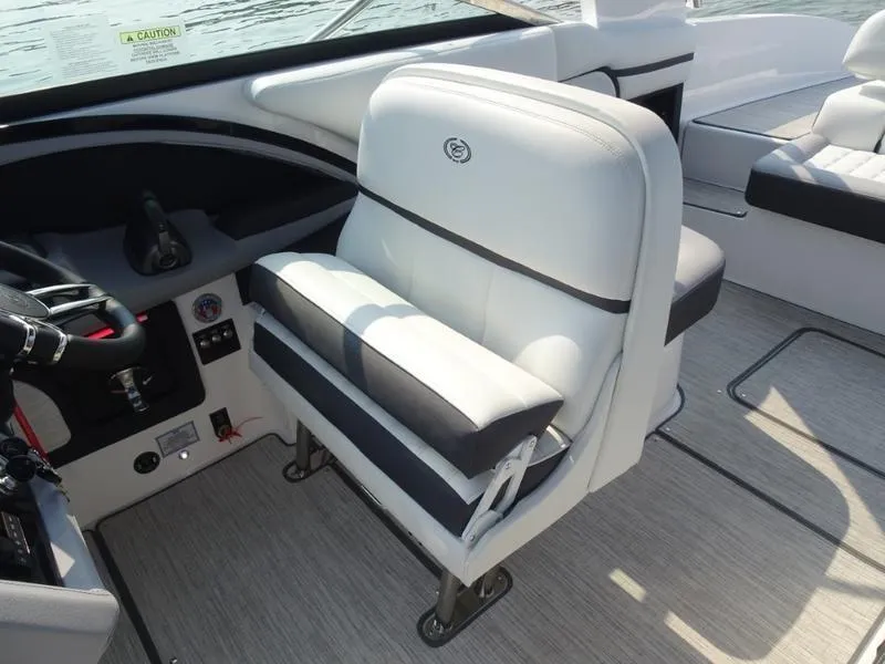 Slide: The Image of Captain's seat of a 2025 Cobalt R30 boat with white and black upholstery. - 17