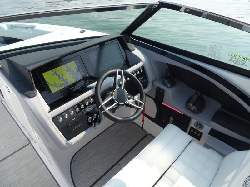 Slide: The Image of 2025 Cobalt R30 boat dashboard with modern navigation system and steering wheel. - 18