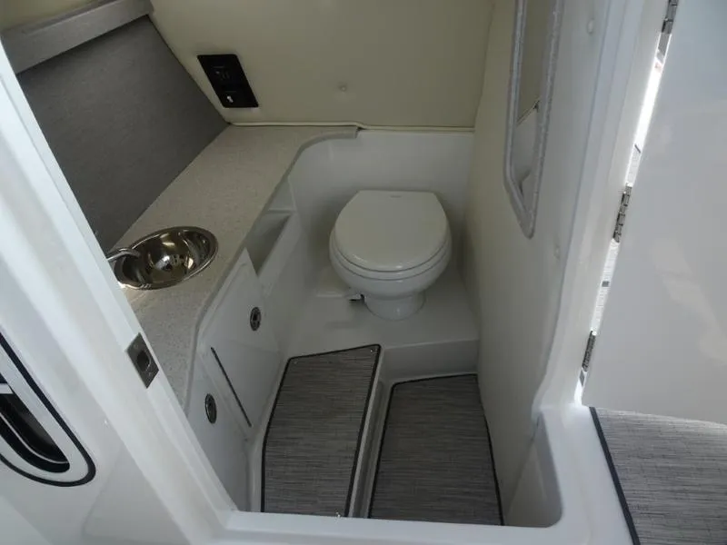 Slide: The Image of 2025 Cobalt R30 boat interior bathroom with toilet and sink. - 23