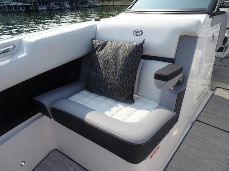Slide: The Image of 2025 Cobalt R30 boat interior with cushioned seating and decorative pillow. - 27