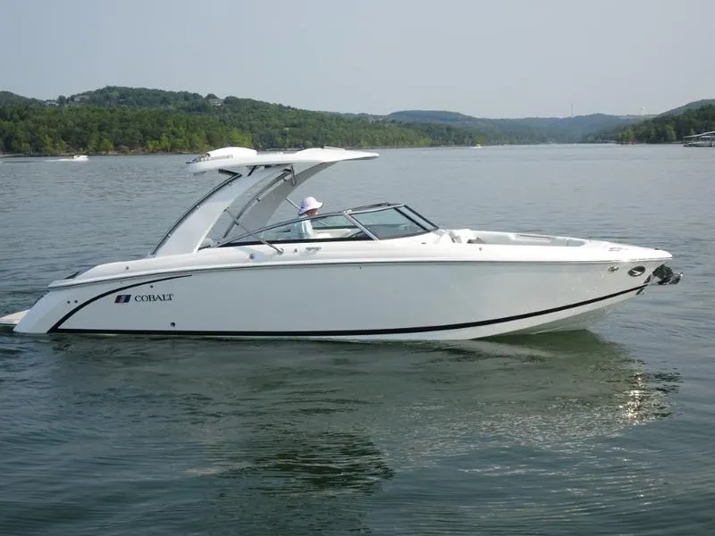 Slide: The Image of 2025 Cobalt R30 boat cruising on a lake with scenic hills in the background. - 3
