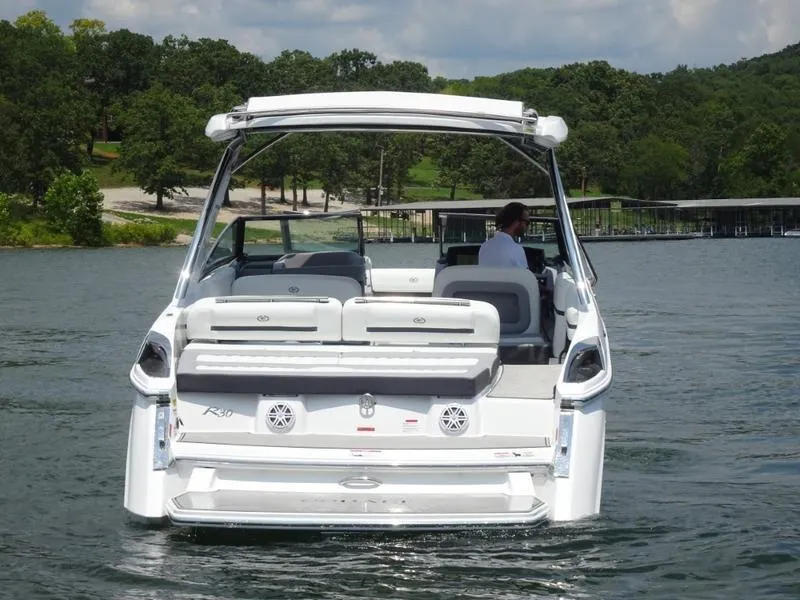 Slide: The Image of 2025 Cobalt R30 boat on a lake with lush green surroundings. - 5