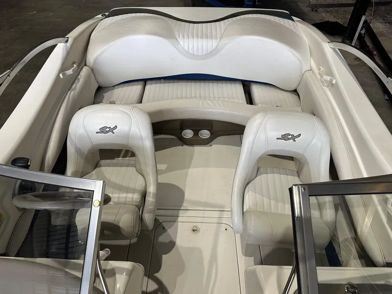 Slide: The Image of 2004 Glastron SX175 boat interior with white leather seats and open windshield. - 12