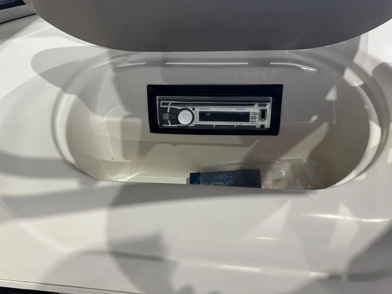 Slide: The Image of 2004 Glastron SX175 boat stereo system in white compartment. - 16
