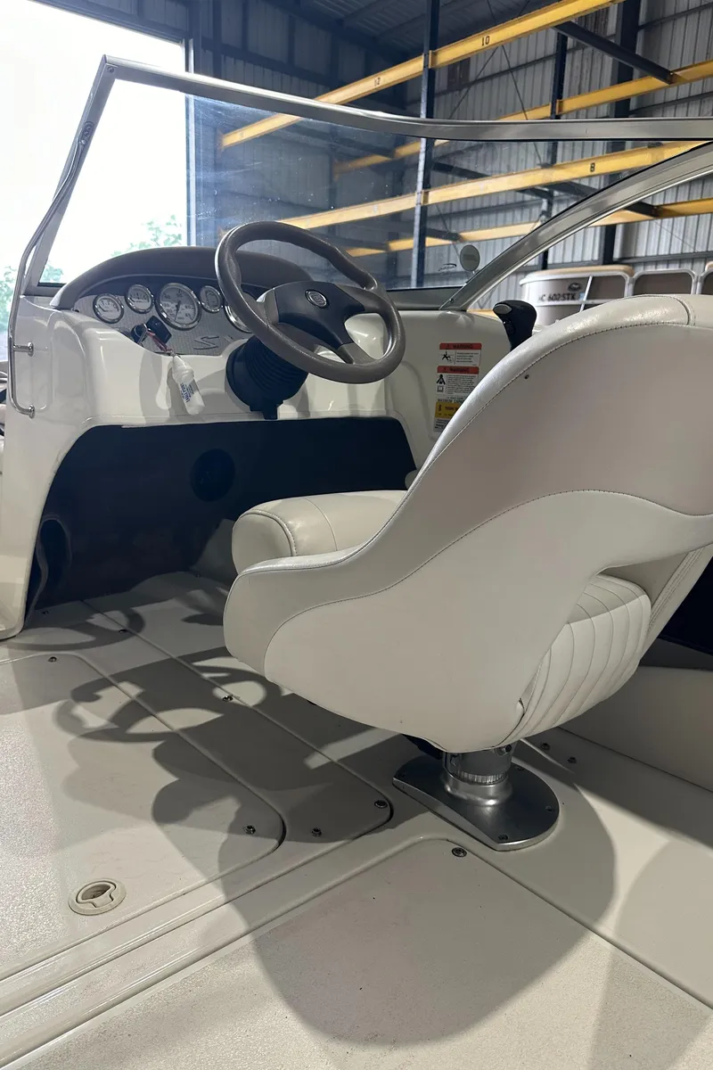 Slide: The Image of 2004 Glastron SX175 boat interior with steering wheel and captain's chair. - 18