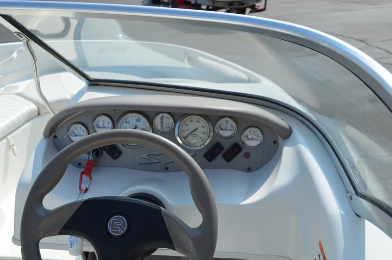 Slide: The Image of 2004 Glastron SX175 boat dashboard with steering wheel and gauges. - 5