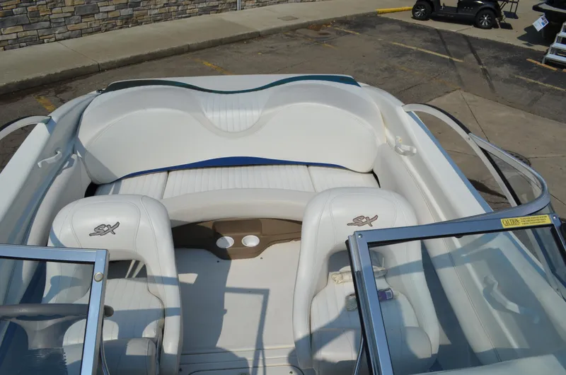 Slide: The Image of 2004 Glastron SX175 boat interior with white seating and open windshield. - 7