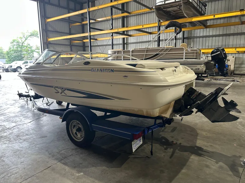 Slide: The Image of 2004 Glastron SX175 boat on trailer in indoor storage facility. - 9