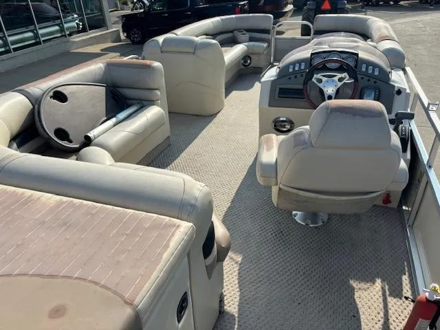 Slide: The Image of 2007 Bennington 2275RL pontoon boat interior with beige seating and captain's chair. - 18