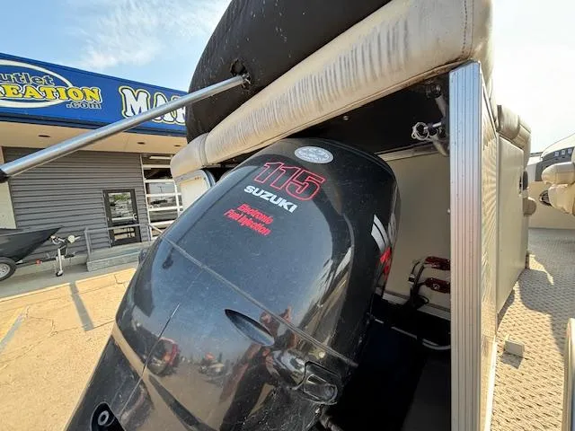 Slide: The Image of 2007 Bennington 2275RL with Suzuki 115 outboard motor at a dealership. - 23