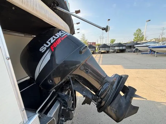 Slide: The Image of 2007 Bennington 2275RL with Suzuki Four Stroke outboard motor in a boatyard. - 24