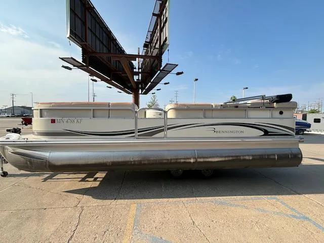 Slide: The Image of 2007 Bennington 2275RL pontoon boat parked on a concrete lot. - 26