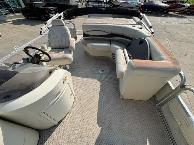 Slide: The Image of 2007 Bennington 2275RL pontoon boat interior with beige seating and steering console. - 6