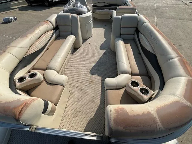 Slide: The Image of 2007 Bennington 2275RL pontoon boat with worn beige and brown seating. - 9