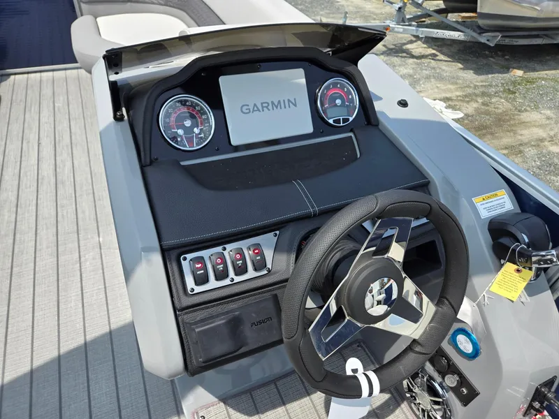 Slide: The Image of 2025 Godfrey Monaco 235 SB boat dashboard with Garmin navigation system. - 14