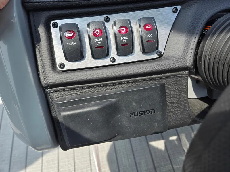 Slide: The Image of Control panel of a 2025 Godfrey Monaco 235 SB boat with labeled switches. - 16