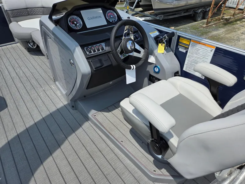 Slide: The Image of 2025 Godfrey Monaco 235 SB boat cockpit with Garmin navigation system and comfortable seating. - 31