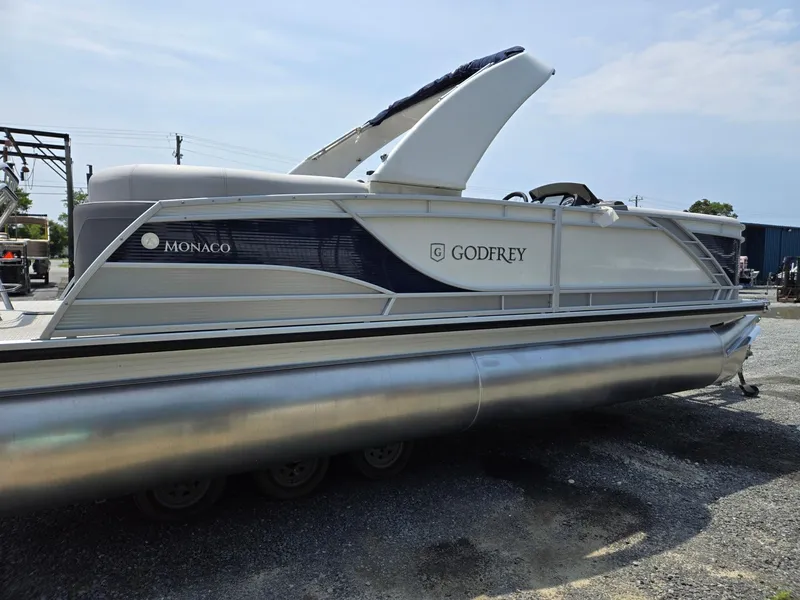 Slide: The Image of 2025 Godfrey Monaco 235 SB pontoon boat on a gravel lot. - 5
