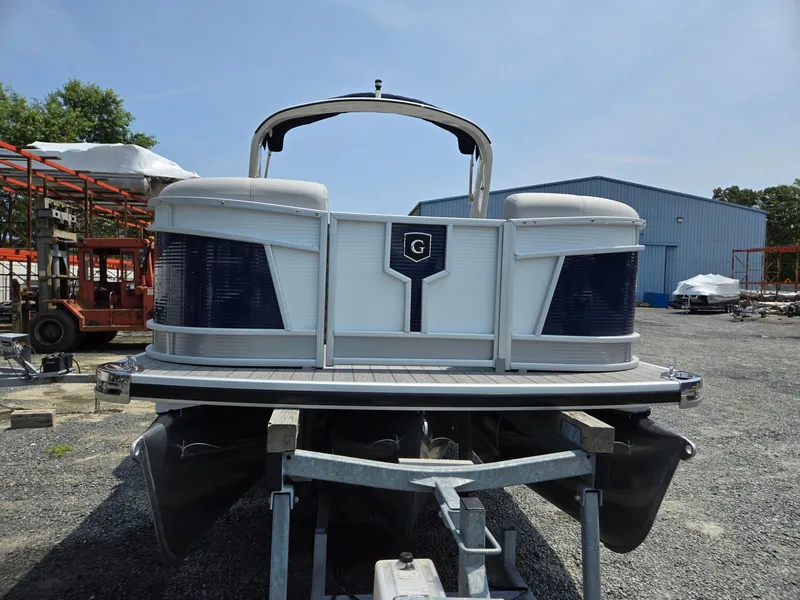Slide: The Image of 2025 Godfrey Monaco 235 SB pontoon boat on trailer in outdoor storage area. - 7