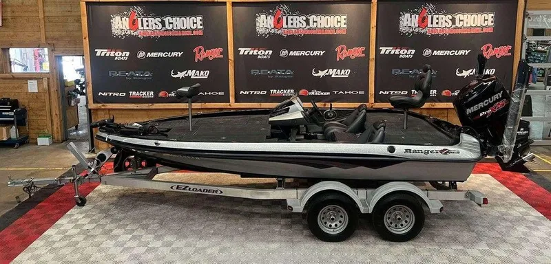 The Image of 2015 Ranger Z118C boat on trailer, displayed indoors with branded backdrop. - 1