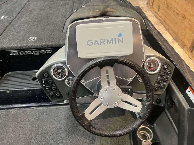 Slide: The Image of 2015 Ranger Z118C boat dashboard with Garmin navigation system and steering wheel. - 6