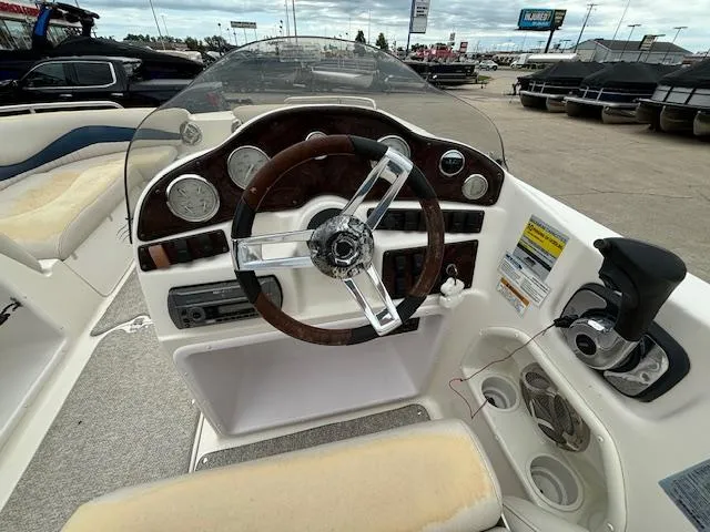 Slide: The Image of 2007 Hurricane 202FD boat dashboard with steering wheel, gauges, and controls. - 11