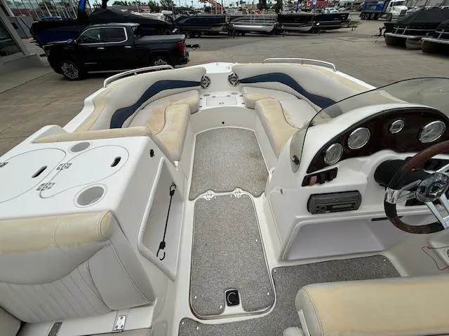 Slide: The Image of 2007 Hurricane 202FD boat interior with seating, steering console, and storage compartments. - 13