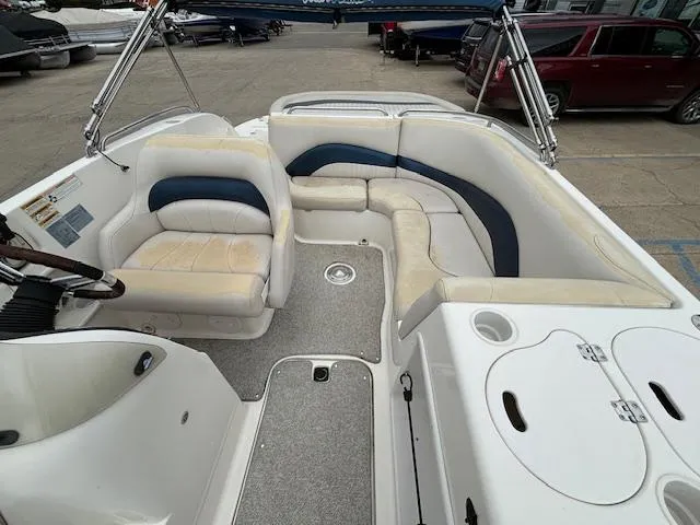 Slide: The Image of 2007 Hurricane 202FD boat interior with white and blue seating, steering wheel, and storage compartments. - 21