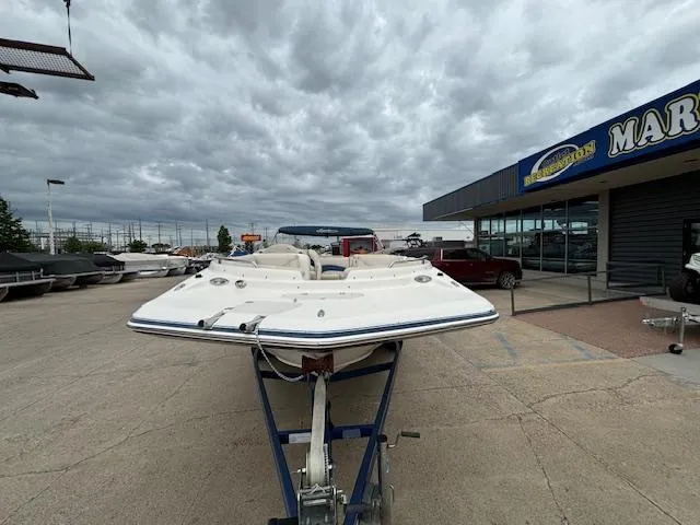 Slide: The Image of 2007 Hurricane 202FD boat on trailer at marina under cloudy sky. - 4