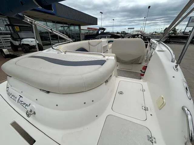 Slide: The Image of 2007 Hurricane 202FD boat interior with white and blue seating, docked at a marina. - 7