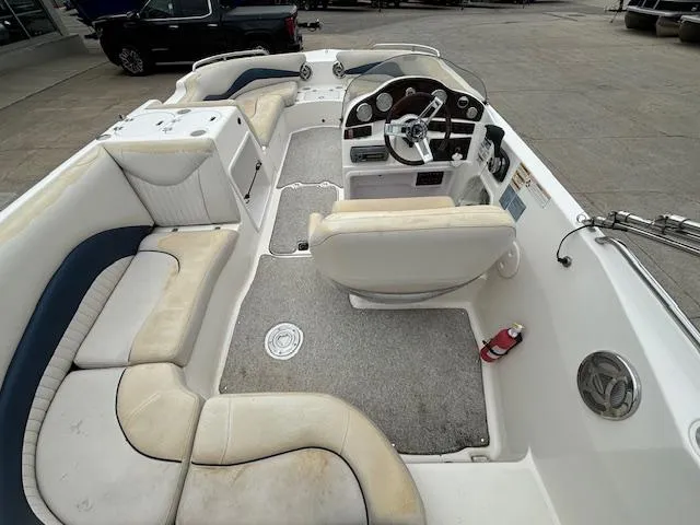 Slide: The Image of 2007 Hurricane 202FD boat interior with seating, steering console, and fire extinguisher. - 9