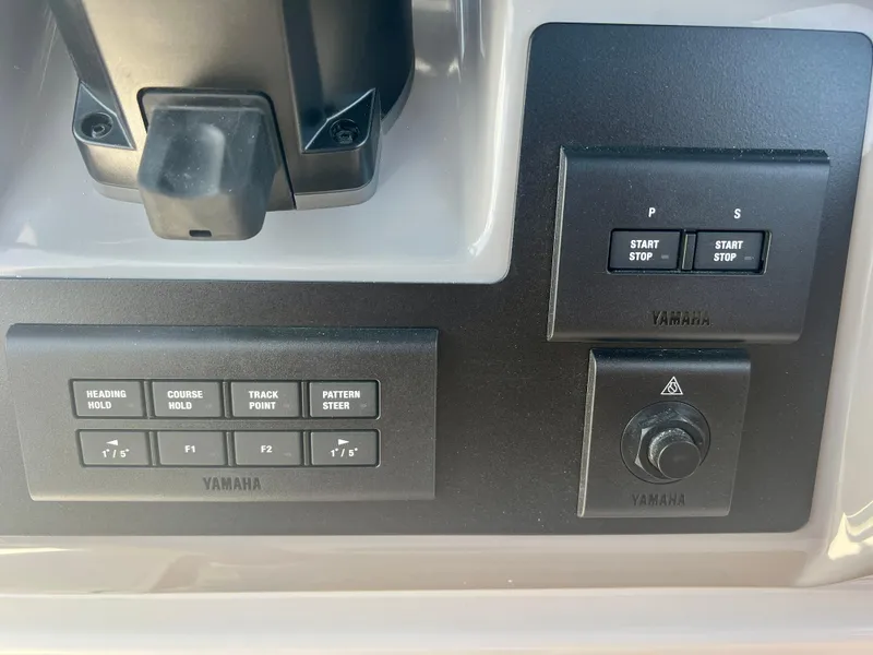 Slide: The Image of Yamaha control panel on 2025 Robalo R270 boat with start/stop buttons and navigation controls. - 21