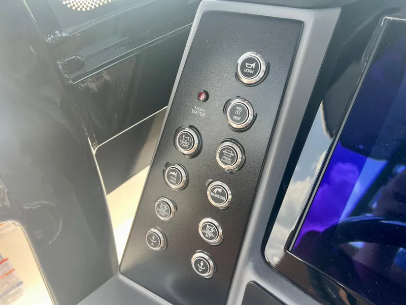 Slide: The Image of Control panel of 2025 Robalo R270 boat with various function buttons. - 25
