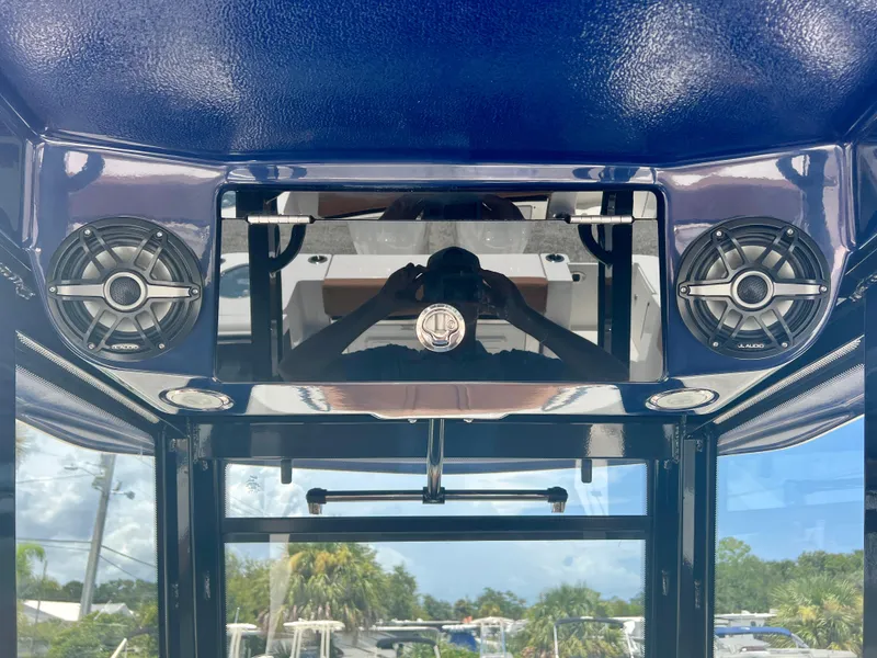 Slide: The Image of 2025 Robalo R270 boat interior with JL Audio speakers and blue finish. - 29