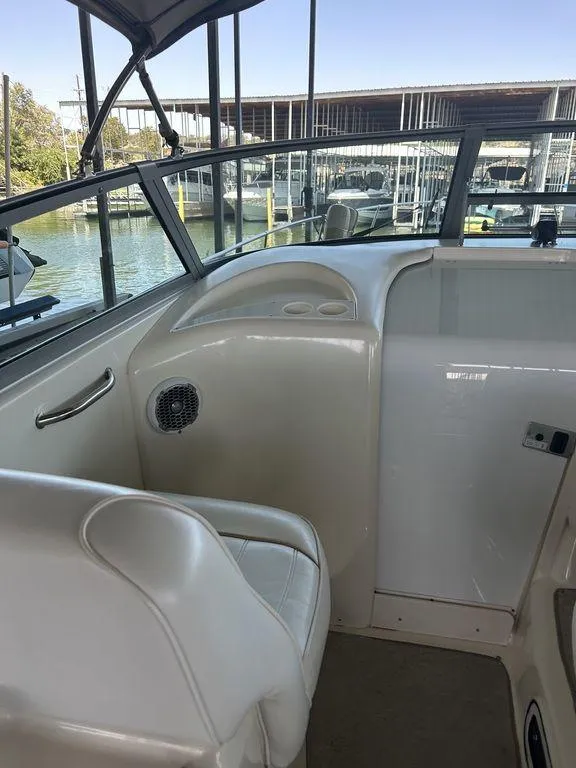 Slide: The Image of Interior view of a 1997 Sea Ray 330 Sundancer boat at a marina. - 11