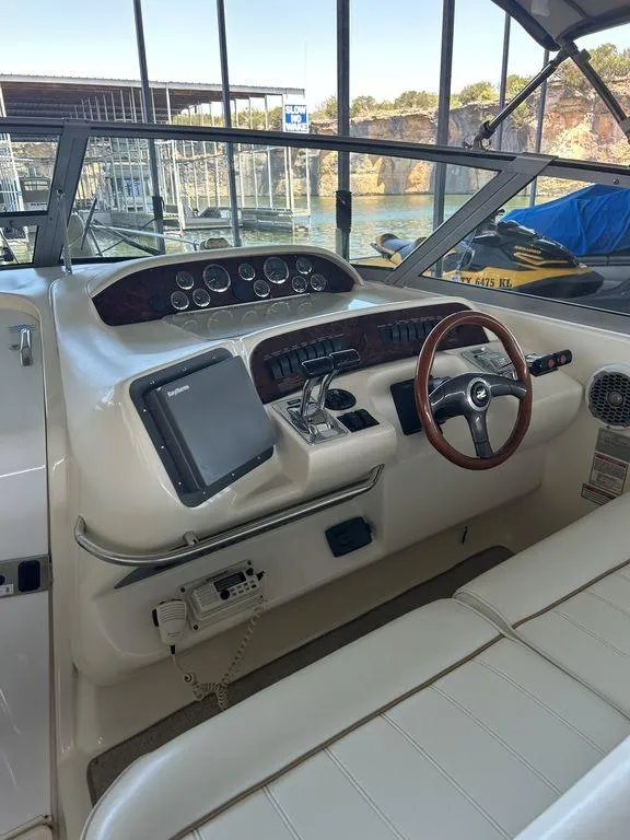 Slide: The Image of 1997 Sea Ray 330 Sundancer boat helm with steering wheel and navigation equipment. - 16