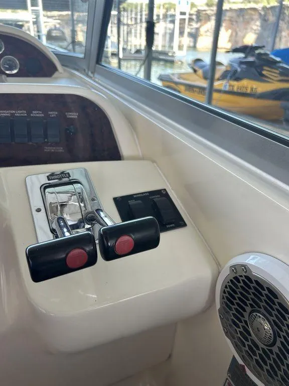 Slide: The Image of Control panel of a 1997 Sea Ray 330 Sundancer boat with throttle levers. - 19