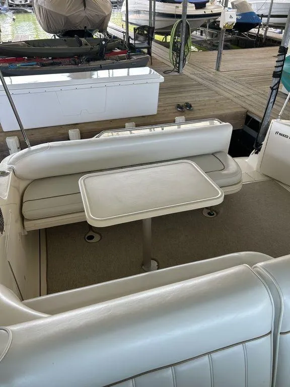 Slide: The Image of 1997 Sea Ray 330 Sundancer boat interior with seating and table. - 21