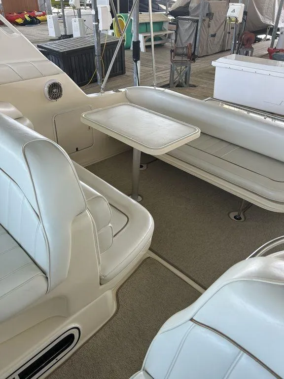 Slide: The Image of 1997 Sea Ray 330 Sundancer boat interior with seating and table. - 22