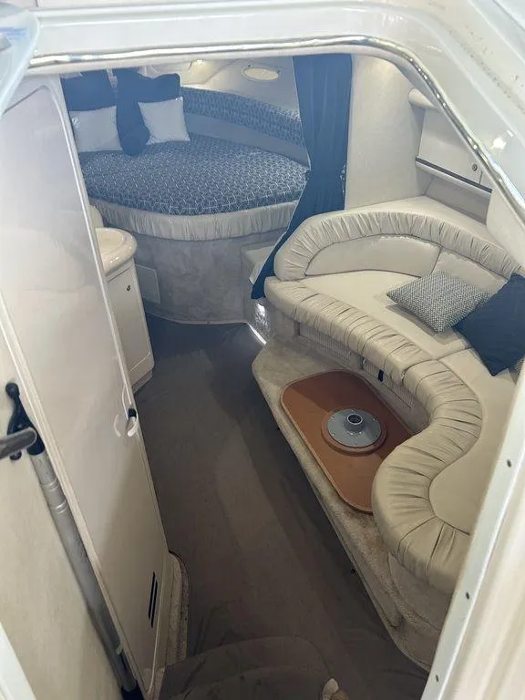 Slide: The Image of 1997 Sea Ray 330 Sundancer cabin interior with seating and bed. - 27