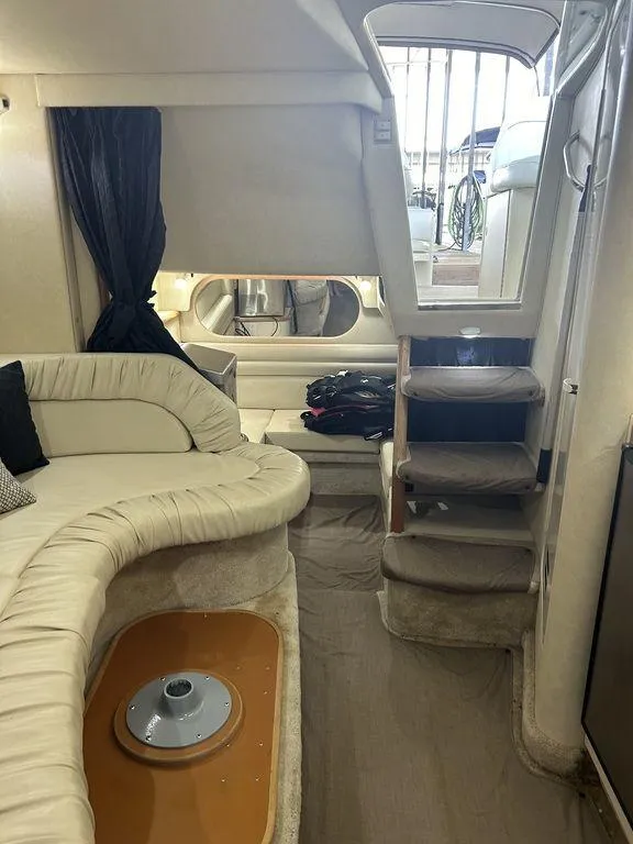 Slide: The Image of Interior of 1997 Sea Ray 330 Sundancer yacht with plush seating and stairs. - 31