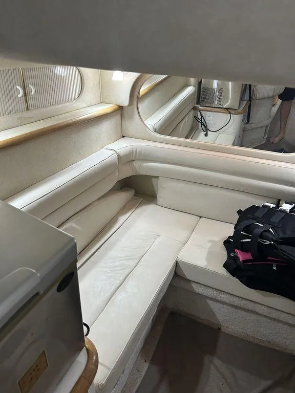 Slide: The Image of Interior of 1997 Sea Ray 330 Sundancer with white leather seating and modern amenities. - 37