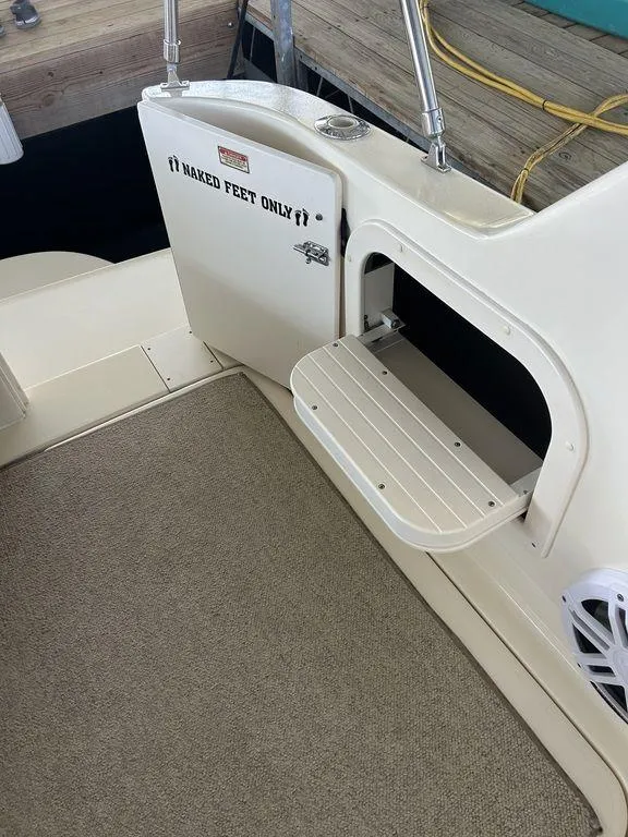 Slide: The Image of 1997 Sea Ray 330 Sundancer boat interior with open storage compartment. - 38