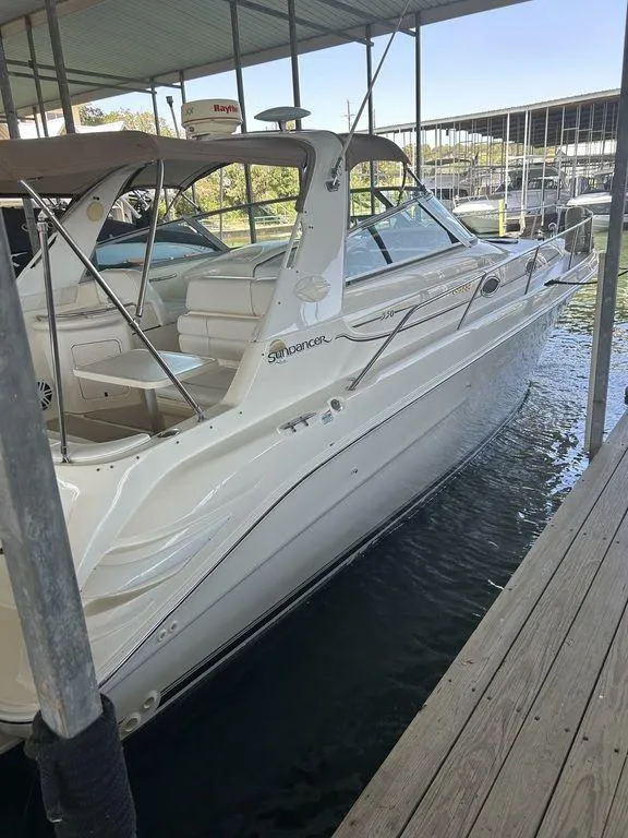 Slide: The Image of 1997 Sea Ray 330 Sundancer docked in a marina, side view. - 4