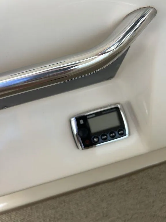 Slide: The Image of Control panel and handrail on a 1997 Sea Ray 330 Sundancer boat. - 40