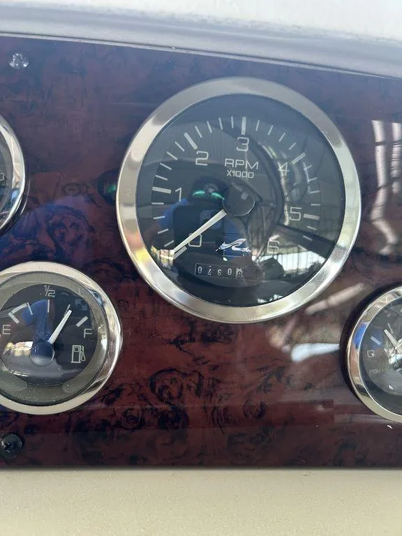 Slide: The Image of Close-up of 1997 Sea Ray 330 Sundancer dashboard gauges, including RPM and fuel indicators. - 41