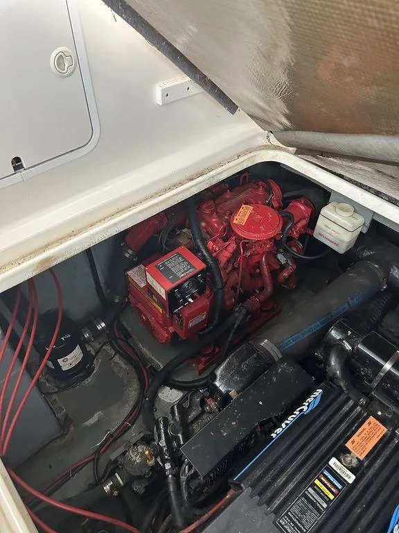 Slide: The Image of 1997 Sea Ray 330 Sundancer engine compartment with visible red engine components. - 45